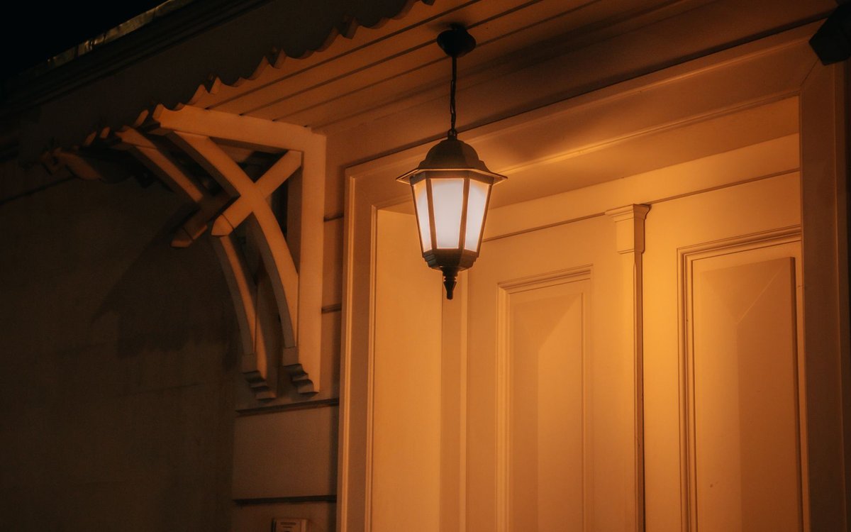 Outdoor LED wall light with warm light at the entrance of a house